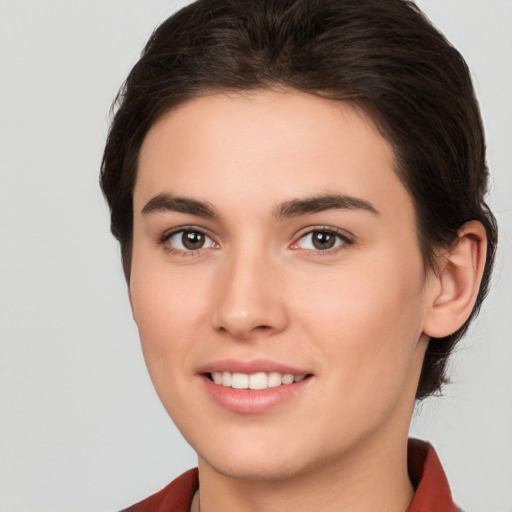 Joyful white young-adult female with medium  brown hair and brown eyes