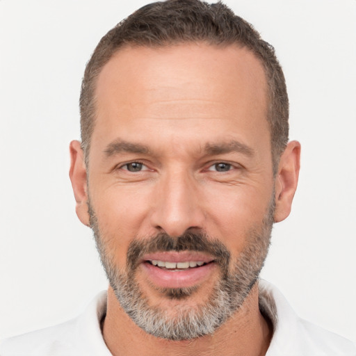 Joyful white adult male with short  brown hair and brown eyes