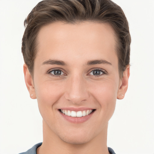 Joyful white young-adult female with short  brown hair and grey eyes