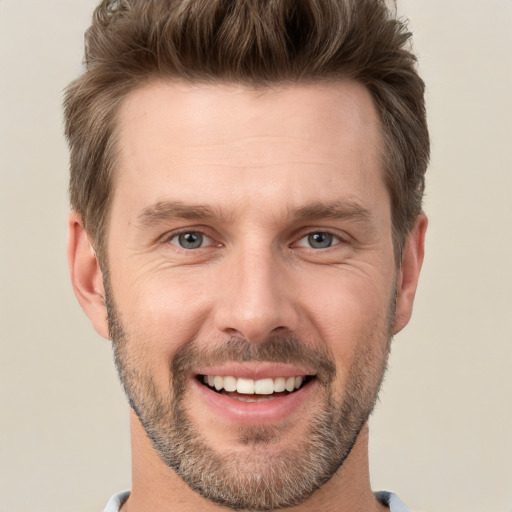 Joyful white adult male with short  brown hair and grey eyes