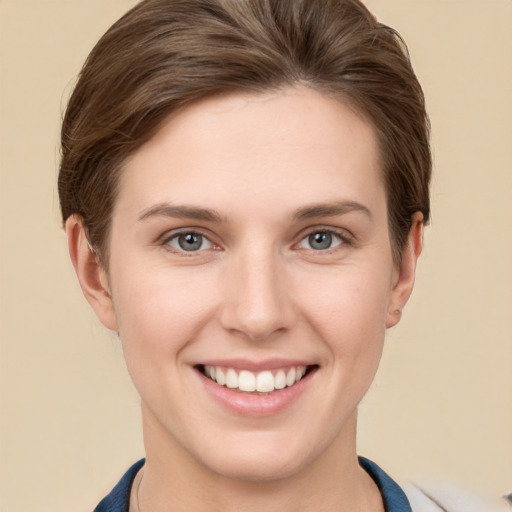 Joyful white young-adult female with short  brown hair and grey eyes