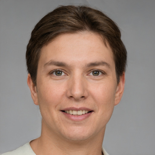 Joyful white young-adult female with short  brown hair and grey eyes