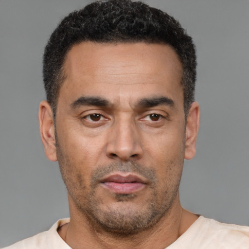Neutral latino adult male with short  black hair and brown eyes