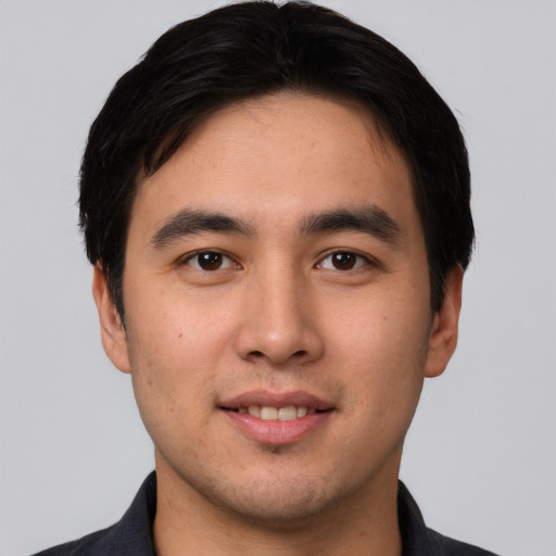 Joyful white young-adult male with short  black hair and brown eyes