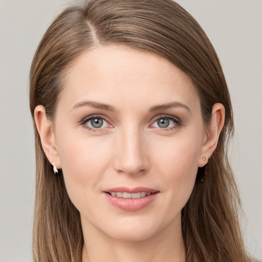 Joyful white young-adult female with long  brown hair and grey eyes