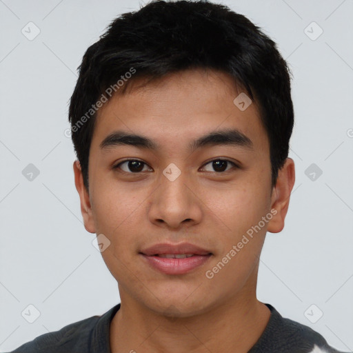 Joyful asian young-adult male with short  black hair and brown eyes