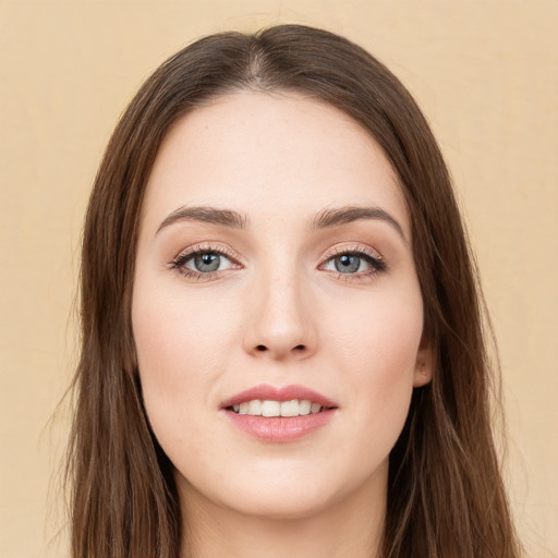 Joyful white young-adult female with long  brown hair and green eyes