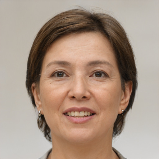 Joyful white adult female with medium  brown hair and brown eyes