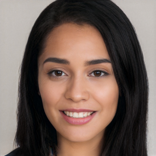 Joyful white young-adult female with long  black hair and brown eyes