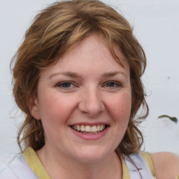 Joyful white young-adult female with medium  brown hair and blue eyes