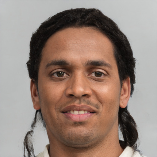 Joyful white young-adult male with short  black hair and brown eyes