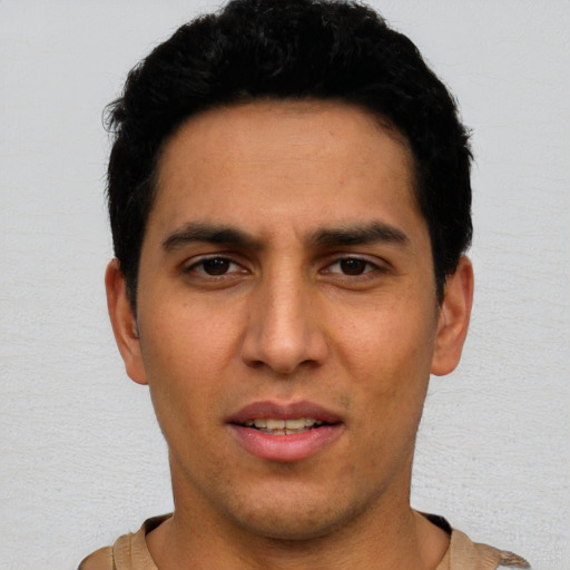 Joyful white young-adult male with short  black hair and brown eyes