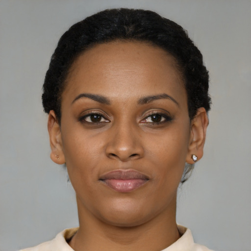Joyful latino young-adult female with short  black hair and brown eyes