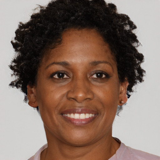 Joyful black adult female with short  brown hair and brown eyes