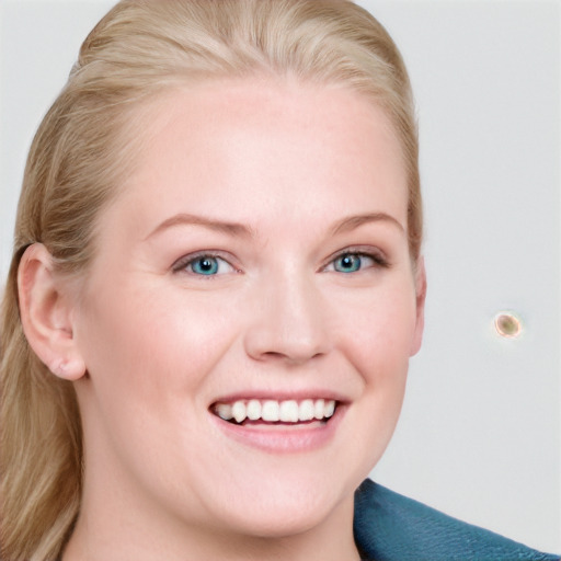 Joyful white young-adult female with long  brown hair and blue eyes