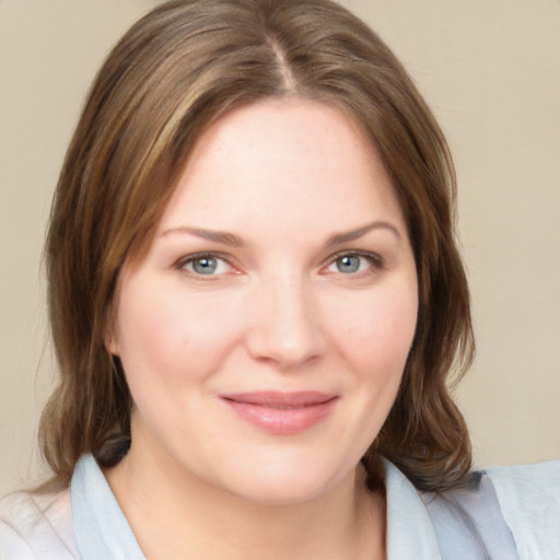 Joyful white young-adult female with medium  brown hair and blue eyes