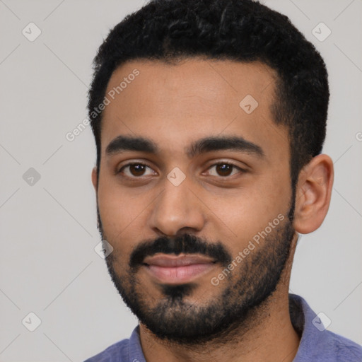 Joyful latino young-adult male with short  black hair and brown eyes