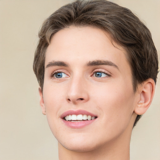 Joyful white young-adult female with short  brown hair and green eyes