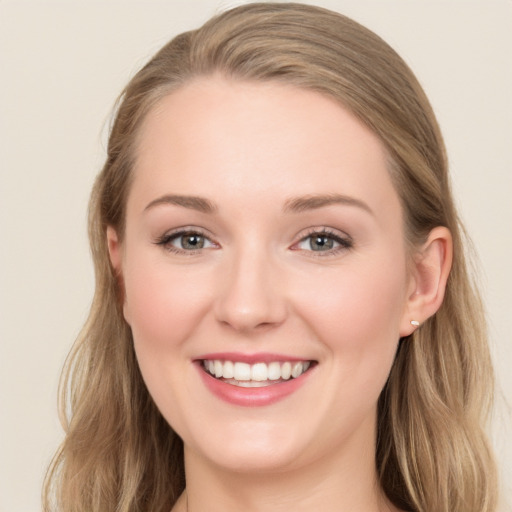 Joyful white young-adult female with long  brown hair and blue eyes