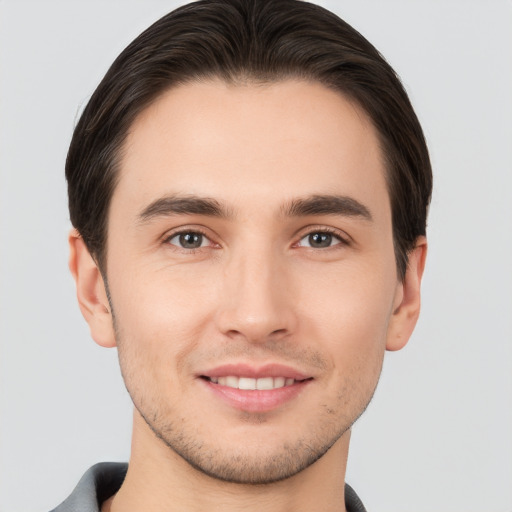 Joyful white young-adult male with short  brown hair and brown eyes