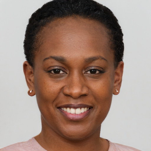Joyful black young-adult female with short  brown hair and brown eyes