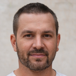 Joyful white adult male with short  brown hair and brown eyes