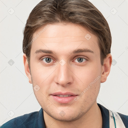 Joyful white young-adult male with short  brown hair and grey eyes