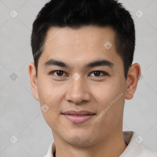 Joyful latino young-adult male with short  black hair and brown eyes