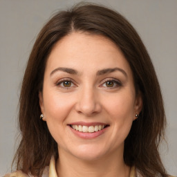 Joyful white young-adult female with medium  brown hair and brown eyes