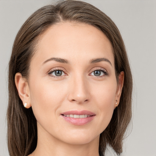 Joyful white young-adult female with long  brown hair and grey eyes