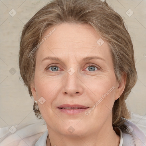 Joyful white adult female with medium  brown hair and blue eyes