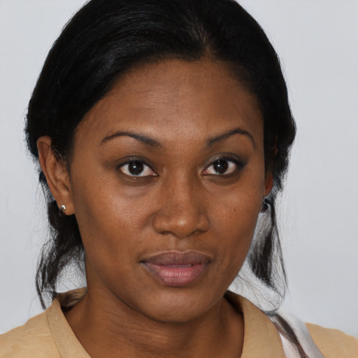 Joyful black young-adult female with medium  brown hair and brown eyes