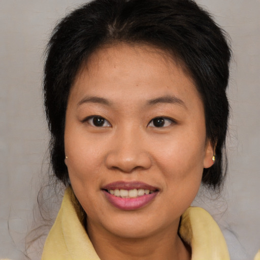 Joyful asian young-adult female with medium  brown hair and brown eyes