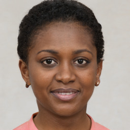 Joyful black young-adult female with short  brown hair and brown eyes