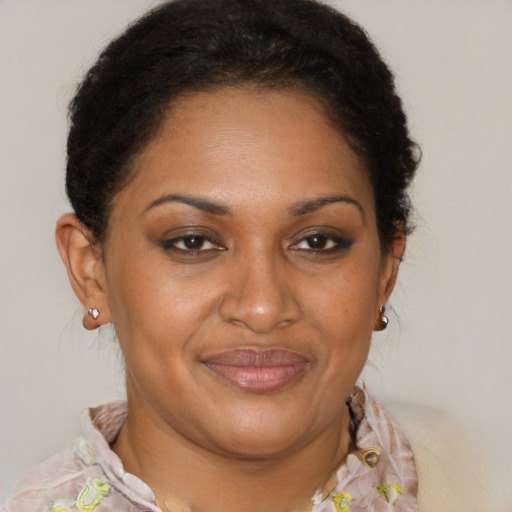 Joyful black young-adult female with short  brown hair and brown eyes