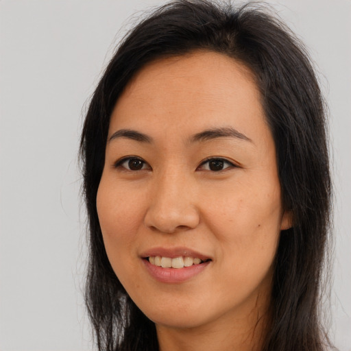 Joyful asian young-adult female with long  brown hair and brown eyes