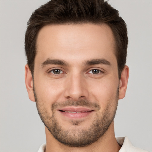 Joyful white young-adult male with short  brown hair and brown eyes