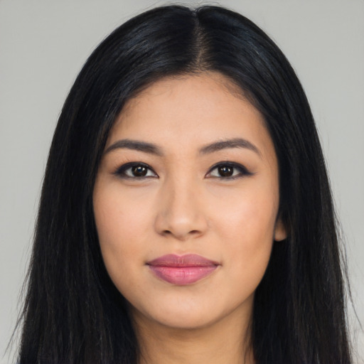 Joyful latino young-adult female with long  black hair and brown eyes