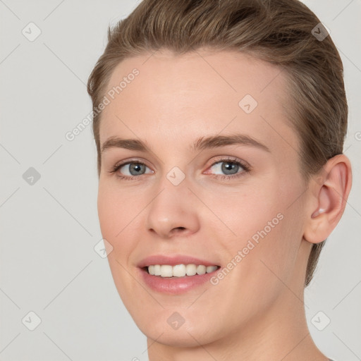 Joyful white young-adult female with short  brown hair and grey eyes