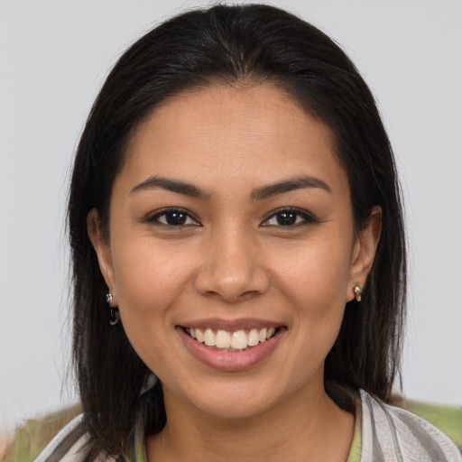 Joyful latino young-adult female with medium  brown hair and brown eyes