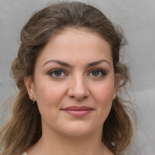 Joyful white young-adult female with medium  brown hair and grey eyes