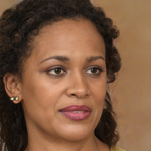 Joyful black young-adult female with medium  brown hair and brown eyes