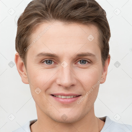 Joyful white young-adult male with short  brown hair and grey eyes