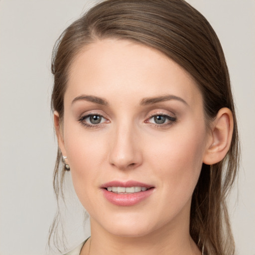 Joyful white young-adult female with long  brown hair and grey eyes