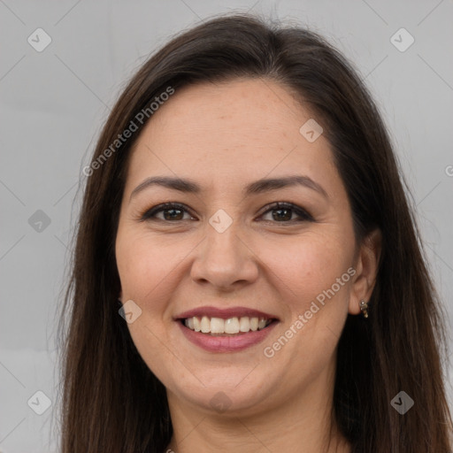 Joyful white adult female with long  brown hair and brown eyes