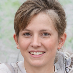 Joyful white young-adult female with medium  brown hair and blue eyes