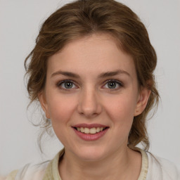 Joyful white young-adult female with medium  brown hair and green eyes