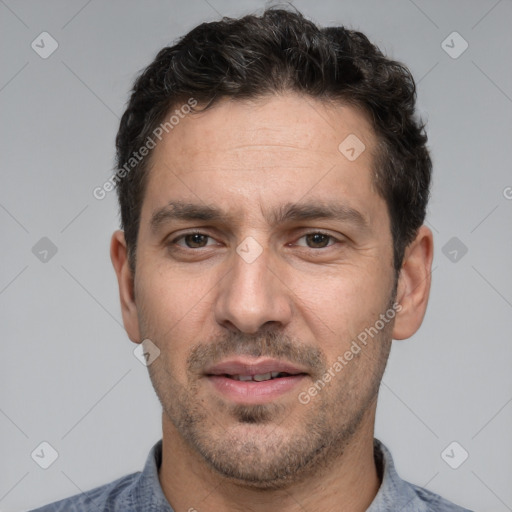 Joyful white adult male with short  black hair and brown eyes