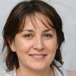 Joyful white adult female with medium  brown hair and brown eyes