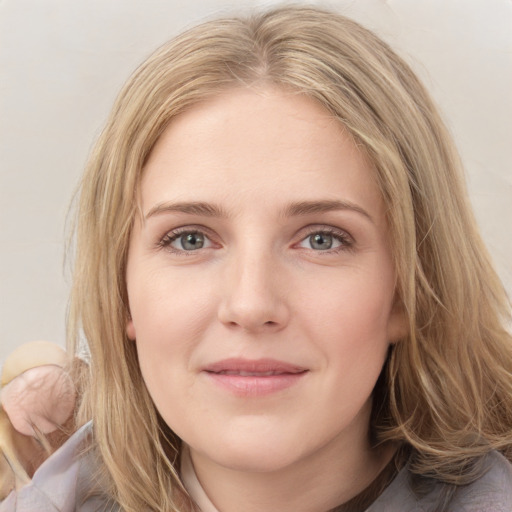 Joyful white young-adult female with medium  brown hair and blue eyes